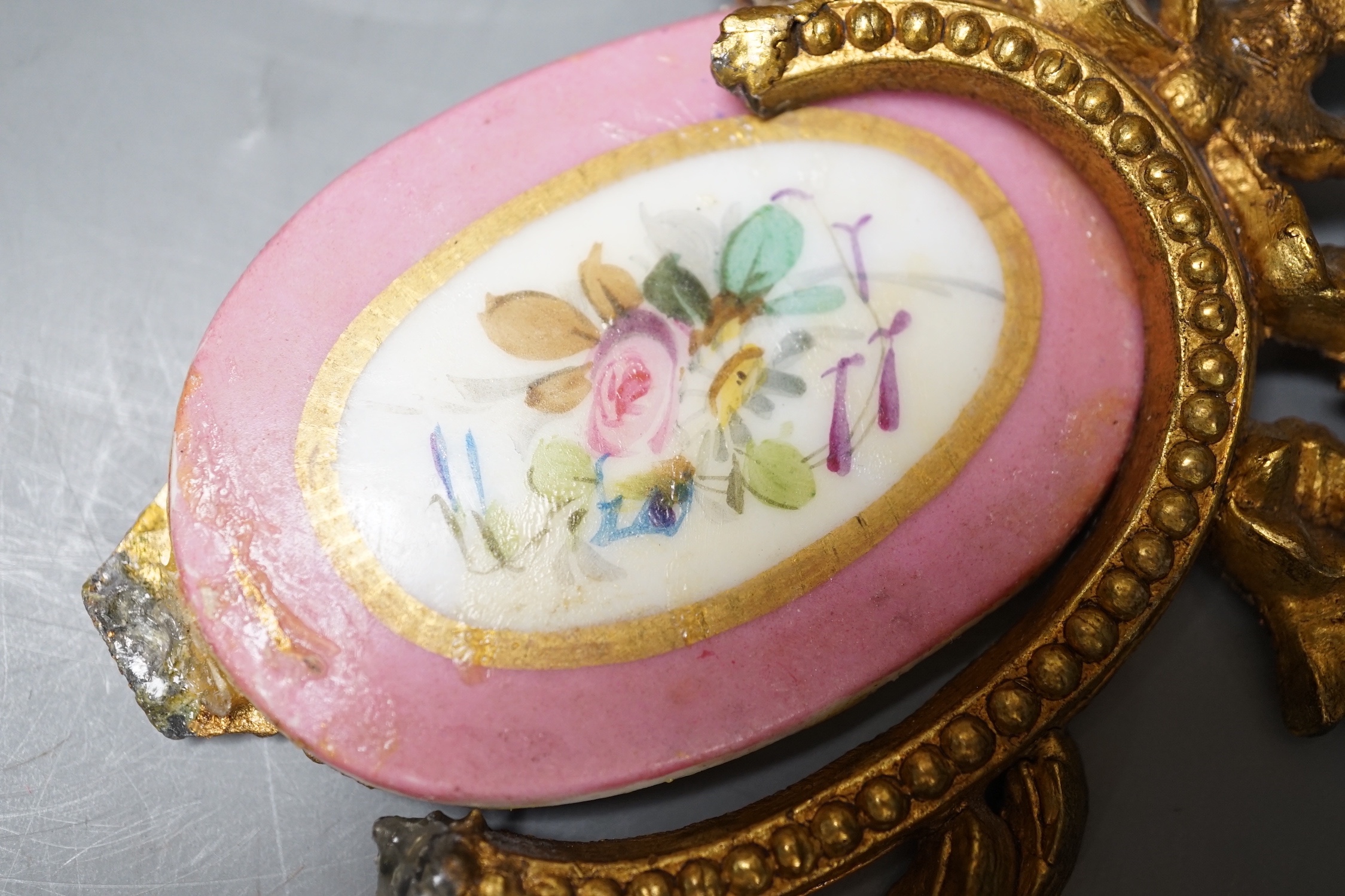 A French gilt metal and porcelain clock garniture. 36.5cm